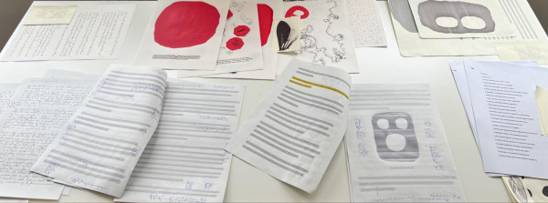 text-like drawings laid out on a table